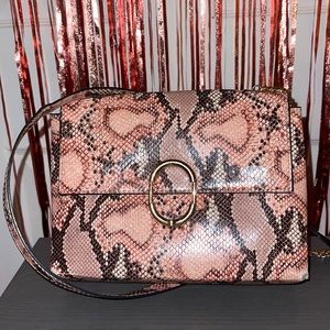 Pink snake print bag with gold detailing and a snake print shoulder strap